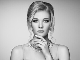 Wall Mural - Portrait Beautiful Blonde Woman with Jewelry. Model Girl with Pearl Manicure on Nails. Elegant Hairstyle. Precious Stones and Silver. Beauty and Fashion Accessories. Perfect Make-Up. Black and White p