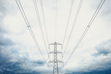 high voltage power lines clouds moody skies