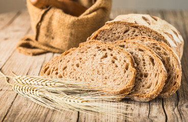 Loaf of bread on rustic wood background. 