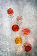 Wall Mural - Top view collection of various wines, white, pink, red on a gray concrete background. Wine tasting concept.