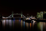 Fototapeta  - HMS Belfast floating on the river Thames next to Tower Bridge