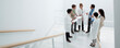 © Martin Barraud/KOTO - Business people and doctors meeting on landing of stairs