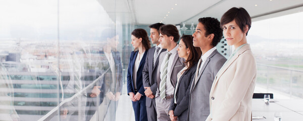 Business people in conference room looking out window