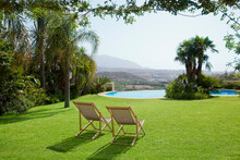 Lawn Chair In Grass Overlooking Swimming Pool