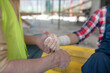 © zinkevych - Close-up of building worker hands applying bandage on his coworker forearm