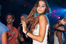 Woman Dancing On Dance Floor In Nightclub