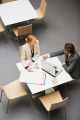 businessman and businesswoman working at cafe