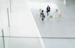 © Martin Barraud/KOTO - Businessmen meeting at circle of chairs in lobby