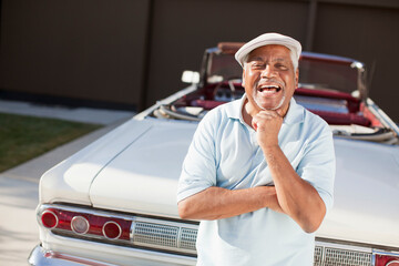 Wall Mural - Older man smiling with convertible