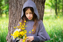 Girl Picking Yellow Wildflowers