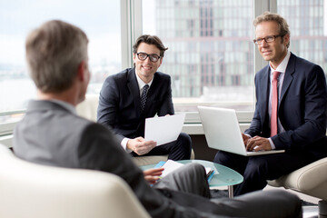 Businessmen talking in office area