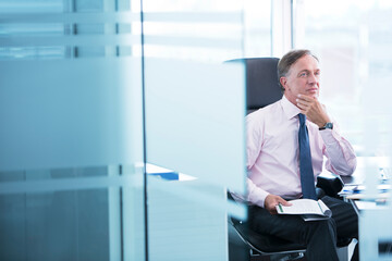 Wall Mural - Businessman thinking at desk