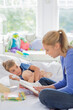 © Tom Merton/KOTO - Mother reading to son in bed