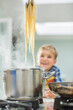 © Tom Merton/KOTO - Boy watching parent cook spaghetti