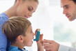© Tom Merton/KOTO - Parents giving son asthma inhaler