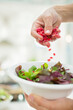 © Tom Merton/KOTO - Woman making salad in kitchen