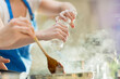 © Tom Merton/KOTO - Couple cooking in kitchen
