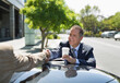 © Paul Bradbury/KOTO - Businessmen shaking hands over car