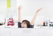© Robert Daly/KOTO - Businesswoman in headset cheering at desk