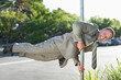 © Robert Daly/KOTO - Businessman balancing on pole on city street