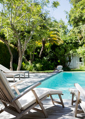 Wall Mural - Lawn chairs and swimming pool in backyard