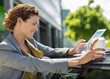 © Paul Bradbury/KOTO - Businesswoman using tablet computer outdoors