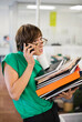 © Paul Bradbury/KOTO - Businesswoman with folders talking on cell phone