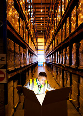 Wall Mural - Worker opening glowing box in warehouse