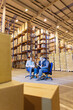© Paul Bradbury/KOTO - Business people talking in warehouse