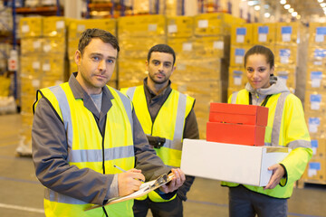 Wall Mural - Workers standing in warehouse