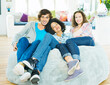© Robert Daly/KOTO - Friends relaxing together in beanbag chair