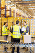 © Paul Bradbury/KOTO - Businessman and workers talking in warehouse