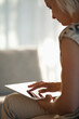 © Sam Edwards/KOTO - Woman using tablet computer on sofa