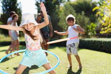 Wall Mural - Children hula hooping in backyard