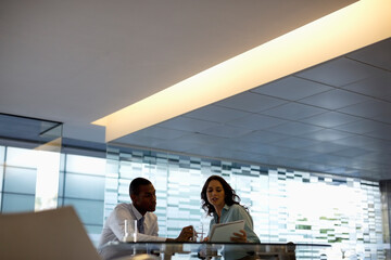 Wall Mural - Businessman and businesswoman discussing paperwork