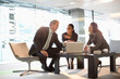 © Tom Merton/KOTO - Business people with laptop meeting in lobby