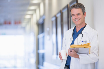 Wall Mural - Portrait of smiling doctor in hospital corridor