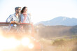 © Martin Barraud/KOTO - Couple standing in sport utility vehicle