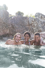 Wall Mural - Friends laughing in river