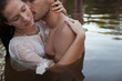 © Sam Edwards/KOTO - Sensual couple kissing in lake