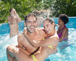 © Sam Edwards/KOTO - Couple playing in swimming pool