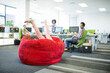 Businesswoman playing in beanbag chair in office