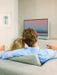 Couple watching television on sofa