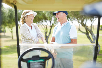 Wall Mural - Senior couple laughing on golf course