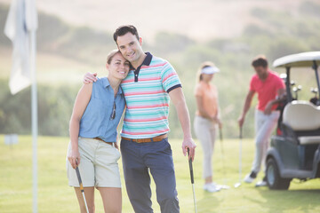 Wall Mural - Couple hugging on golf course