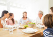 © Robert Daly/KOTO - Multi-generation family eating together at table