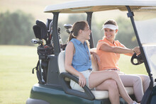 Women Driving Cart On Golf Course