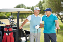 Senior Men Laughing Next To Golf Cart