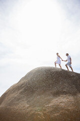 Wall Mural - Couple walking on rock formation