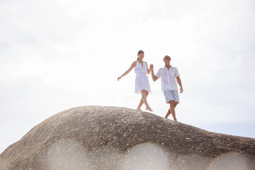 Wall Mural - Couple walking on rock formation